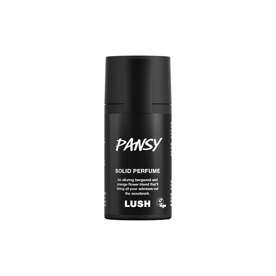 Pansy. A short, cylindrical black push-up tube of the Pansy solid perfume with a black label on the front covering the cap, with the product name and scent printed on it.
